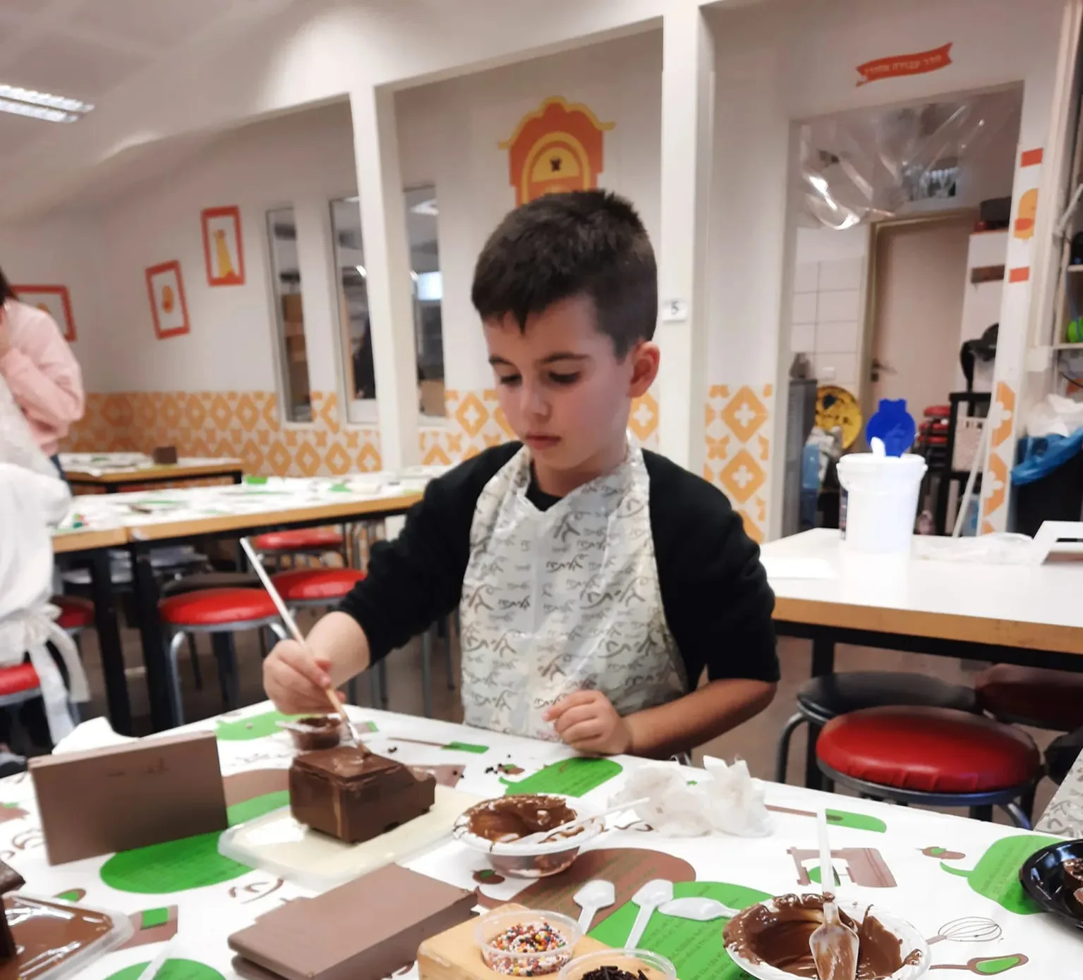 A young artist painting at a creative workshop